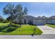 Single-story home with two-car garage and manicured lawn at 76 Long Meadow Ct, Rotonda West, FL 33947
