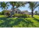Well-maintained house with lush landscaping and palm trees at 76 Long Meadow Ct, Rotonda West, FL 33947