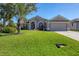 One-story home with attractive landscaping and a two-car garage at 76 Long Meadow Ct, Rotonda West, FL 33947