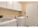 Laundry room featuring white washer and dryer, white cabinets, and a door to another room at 76 Long Meadow Ct, Rotonda West, FL 33947