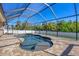 Inviting in-ground pool with screened-in enclosure offers a private oasis for relaxation and recreation at 76 Long Meadow Ct, Rotonda West, FL 33947