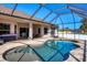 Gorgeous pool and patio are accessible from home via covered lanai, all fully enclosed at 76 Long Meadow Ct, Rotonda West, FL 33947