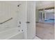 Bathroom with shower/tub combo and access to the pool area at 8508 Gateway Ct, Englewood, FL 34224