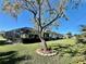 Backyard with a large tree and a view of the pool and house at 885 Bay Vista Blvd, Englewood, FL 34223