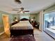 Spacious bedroom with ensuite bathroom access and sliding doors to patio at 885 Bay Vista Blvd, Englewood, FL 34223