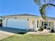 House exterior showcasing a white garage door and well-maintained landscaping at 885 Bay Vista Blvd, Englewood, FL 34223