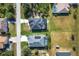 The aerial view highlights well-maintained houses with screened pools and manicured lawns in a quiet neighborhood at 9157 Genesee St, Port Charlotte, FL 33981