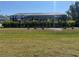 This is a lovely backyard view showing the lawn, landscaping and screened-in patio of the home at 9157 Genesee St, Port Charlotte, FL 33981