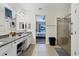 Bathroom with granite countertop, double vanity, and a view to the bedroom at 9157 Genesee St, Port Charlotte, FL 33981