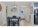 Dining area with tile floors, a dark wood table, four chairs and a modern lighting fixture at 9157 Genesee St, Port Charlotte, FL 33981