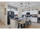 Modern kitchen with white cabinets, dark countertops, stainless steel appliances, and island seating at 9157 Genesee St, Port Charlotte, FL 33981