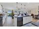 Open-concept kitchen with island, connecting seamlessly to the living area with a Christmas tree at 9157 Genesee St, Port Charlotte, FL 33981