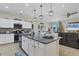 Well-appointed kitchen with island, stainless steel appliances, and open sightlines to the living room at 9157 Genesee St, Port Charlotte, FL 33981