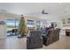 Inviting living room space featuring a Christmas tree, tile flooring, and sliding doors to the patio at 9157 Genesee St, Port Charlotte, FL 33981