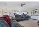 Spacious living room with comfortable reclining sofa, open to the kitchen and dining area at 9157 Genesee St, Port Charlotte, FL 33981