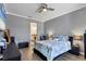 Main bedroom with gray walls, ceiling fan, and ensuite bathroom access at 9157 Genesee St, Port Charlotte, FL 33981
