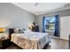 Main bedroom featuring a window with backyard views and blue curtains at 9157 Genesee St, Port Charlotte, FL 33981