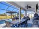 Covered patio with dining table next to the pool, ideal for outdoor entertaining at 9157 Genesee St, Port Charlotte, FL 33981