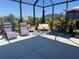 Screened patio with lounge chairs and seating area, perfect for enjoying the outdoors at 9157 Genesee St, Port Charlotte, FL 33981