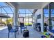 Comfortable screened patio with outdoor seating and a grill, perfect for relaxing and entertaining at 9157 Genesee St, Port Charlotte, FL 33981