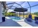 Screened-in swimming pool with lounge chairs, providing a private and refreshing outdoor space at 9157 Genesee St, Port Charlotte, FL 33981