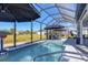 Enjoy this stunning screened-in pool with an in-ground pool, patio, and well-maintained outdoor space at 9157 Genesee St, Port Charlotte, FL 33981