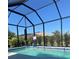 Relax by the screened-in pool, which includes a basketball hoop and lush landscaping for a tranquil retreat at 9157 Genesee St, Port Charlotte, FL 33981
