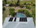 Aerial view showcasing a home with solar panels and a screened pool at 97 Mariner Ln, Rotonda West, FL 33947