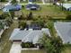 Aerial view of a house with a pool and solar panels on the roof at 97 Mariner Ln, Rotonda West, FL 33947