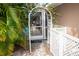 Charming backyard with a white arbor and gate at 97 Mariner Ln, Rotonda West, FL 33947
