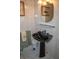 Bathroom with pedestal sink and tiled walls at 97 Mariner Ln, Rotonda West, FL 33947