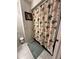Bathroom with tub shower, patterned shower curtain, and tiled walls at 97 Mariner Ln, Rotonda West, FL 33947