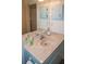 Bathroom with blue vanity and a large mirror at 97 Mariner Ln, Rotonda West, FL 33947