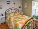 Bedroom with metal bed frame and colorful bedding at 97 Mariner Ln, Rotonda West, FL 33947