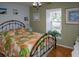 Bedroom with metal bed frame and leafy bedding at 97 Mariner Ln, Rotonda West, FL 33947