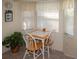 Cozy breakfast nook with a small table and three chairs, overlooking a window at 97 Mariner Ln, Rotonda West, FL 33947