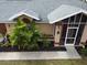 Close-up exterior view of a house entrance with landscaping at 97 Mariner Ln, Rotonda West, FL 33947