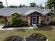 Exterior view of a single-Gathering home with a screened porch at 97 Mariner Ln, Rotonda West, FL 33947