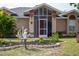 Front view of the house showcasing its entrance and landscaping at 97 Mariner Ln, Rotonda West, FL 33947