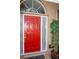 Eye-catching red front door with a unique door knocker at 97 Mariner Ln, Rotonda West, FL 33947