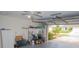 Attached garage with ample storage and lawnmower at 97 Mariner Ln, Rotonda West, FL 33947