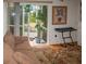 Cozy Gathering room featuring a comfy couch and access to a screened porch at 97 Mariner Ln, Rotonda West, FL 33947