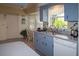 Kitchen with light blue cabinets, a double sink, and a dishwasher at 97 Mariner Ln, Rotonda West, FL 33947