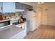 Kitchen with light blue cabinets and white appliances at 97 Mariner Ln, Rotonda West, FL 33947