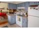 Bright kitchen with light blue cabinets, white appliances, and ample counter space at 97 Mariner Ln, Rotonda West, FL 33947