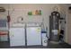 Interior view of a laundry room with washer, dryer, and water heater at 97 Mariner Ln, Rotonda West, FL 33947