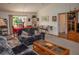 Living room with dark sofas, a coffee table, and built-in shelving at 97 Mariner Ln, Rotonda West, FL 33947