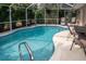 Enjoy this refreshing screened pool with patio seating at 97 Mariner Ln, Rotonda West, FL 33947