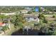 Aerial view showcasing a canal-front home with a pool and dock at 10265 Sunday Dr, Port Charlotte, FL 33981