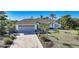 House with gray garage door and landscaped yard at 10265 Sunday Dr, Port Charlotte, FL 33981